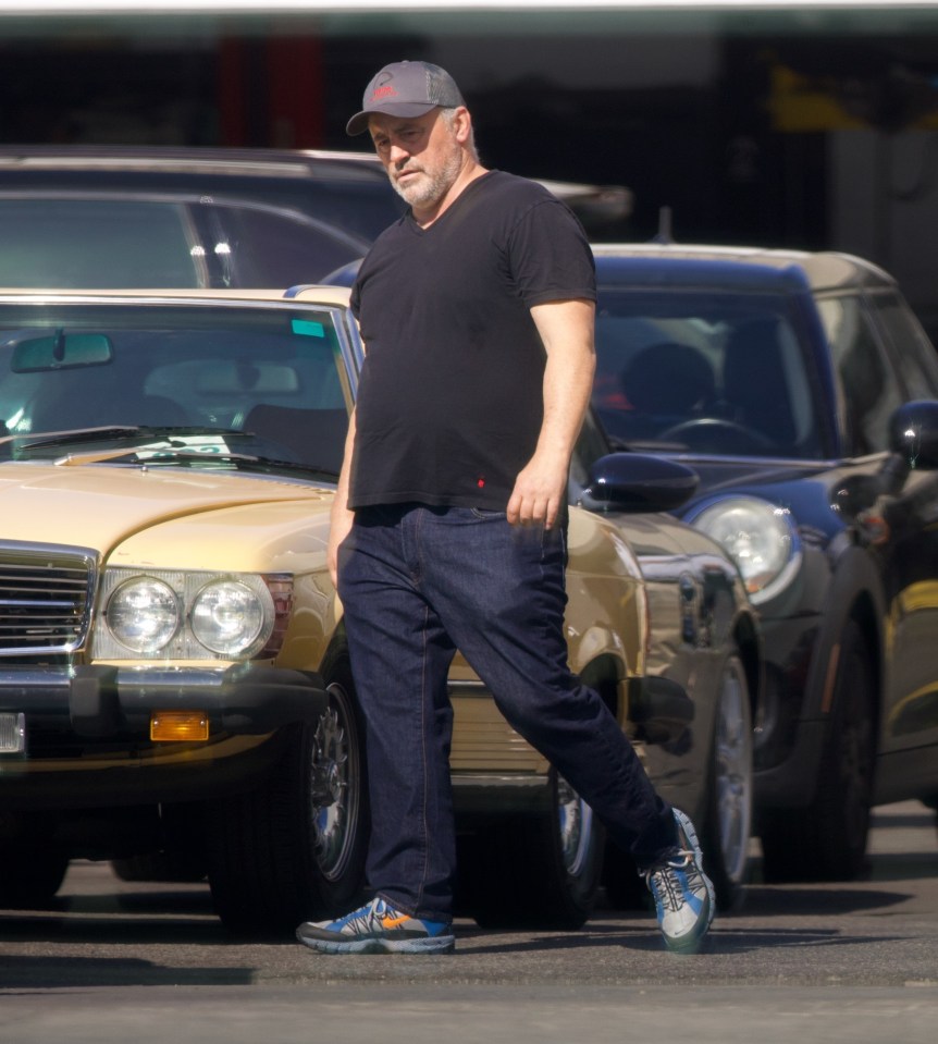 He looked relaxed in a black tee, cap, jeans and trainers