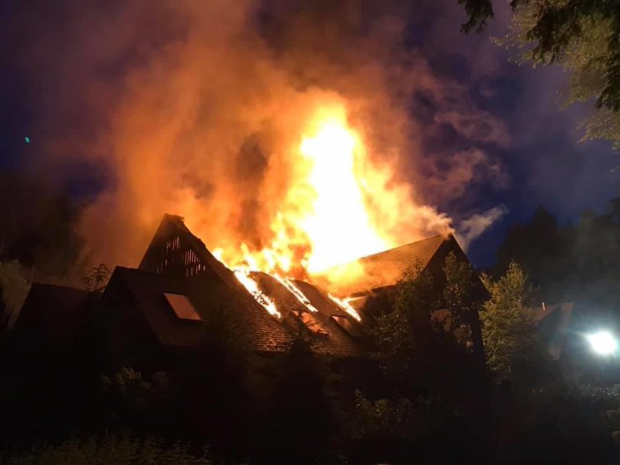 The house is enveloped in smoke and flames in this photo taken on the day of the fire