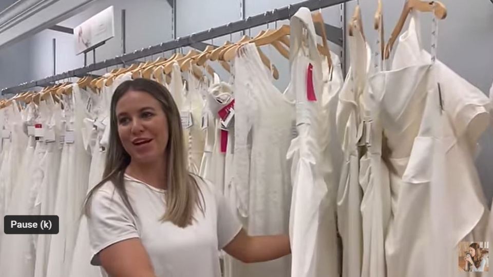 Jana Duggar looking through wedding dresses in the vlog post