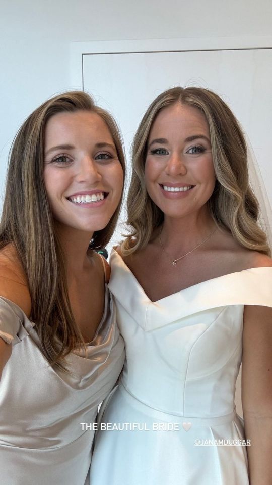 Jana Duggar wearing the wedding dress she picked out while standing next to her sister Joy-Anna