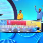 Ryan Seacrest points as three "Wheel of Fortune" contestants cheer.