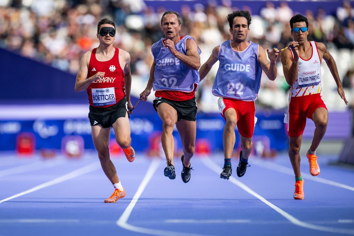 Marcel Boettger and Guide Alexander Kosenkow of Team Germany, Guide Guillermo Rojo Gil and Joan Munar Martinez of Spain competes during the Men's 100m - T11