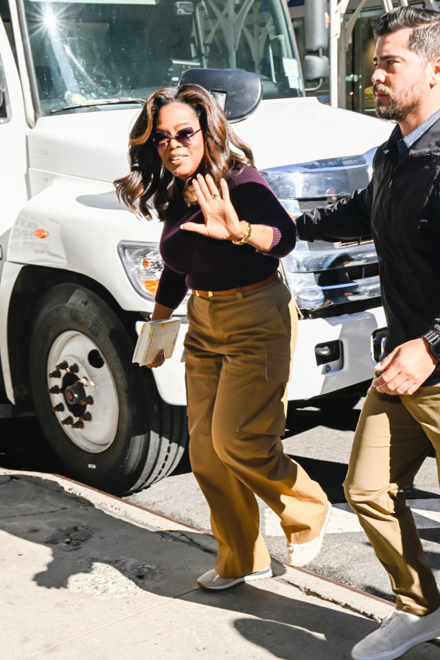 Oprah Winfrey waving to photographers and fans while arriving at the Good Morning America studios in New York City