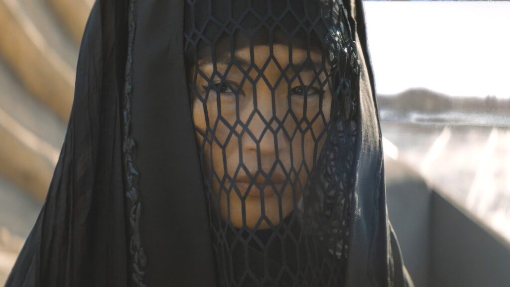 Jihae as Reverend Mother Kasha with her black hood and veil on Dune: Prophecy