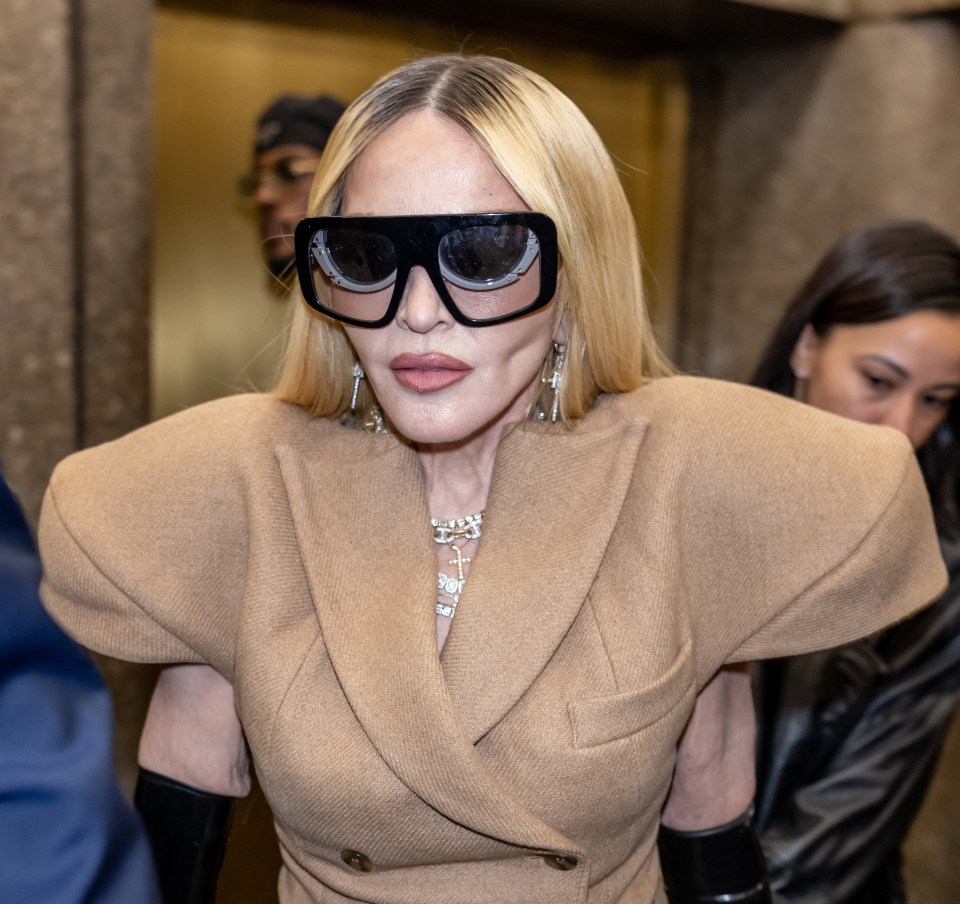 Madonna was channelling robot vibes in big glasses and this camel-coloured dress