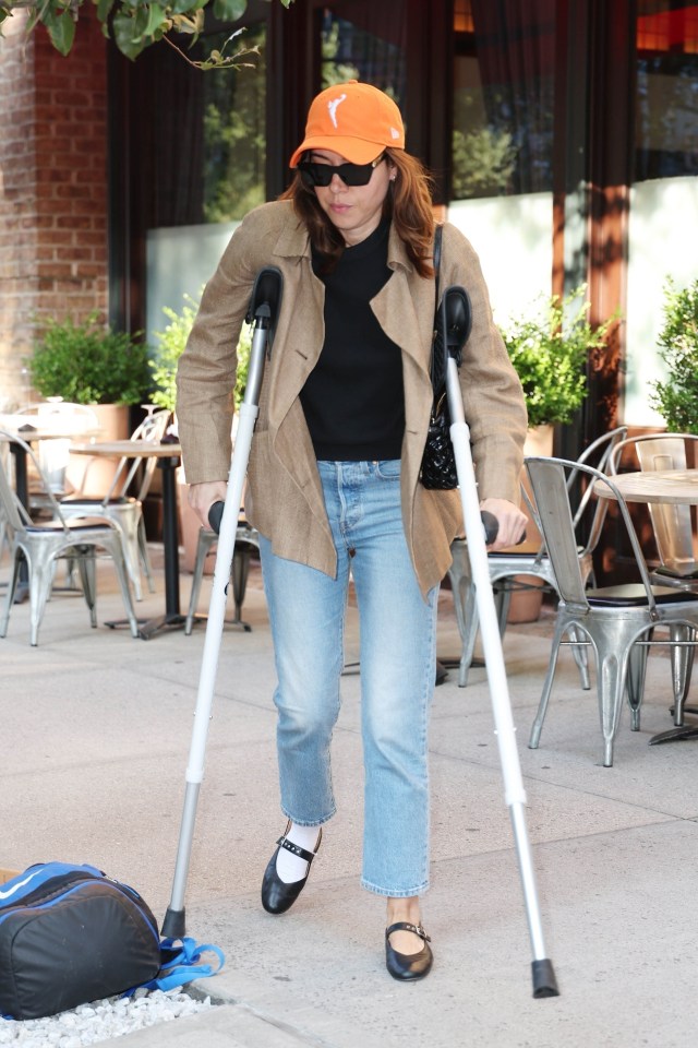 Aubrey Plaza pictured using crutches traversing around New York City