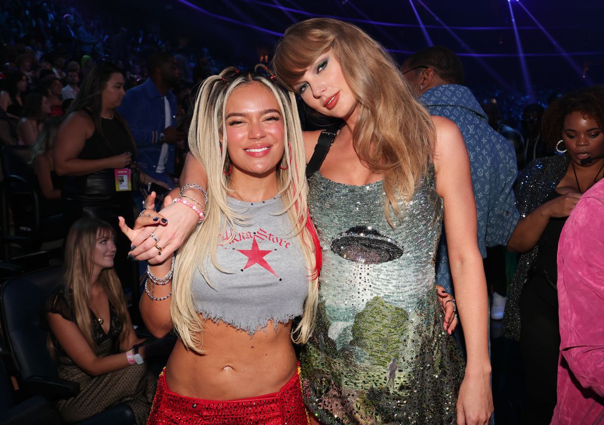 Karol G and Taylor Swift post at the VMAs after her performance 