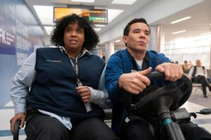 A woman riding in a cart with a man who is driving it.