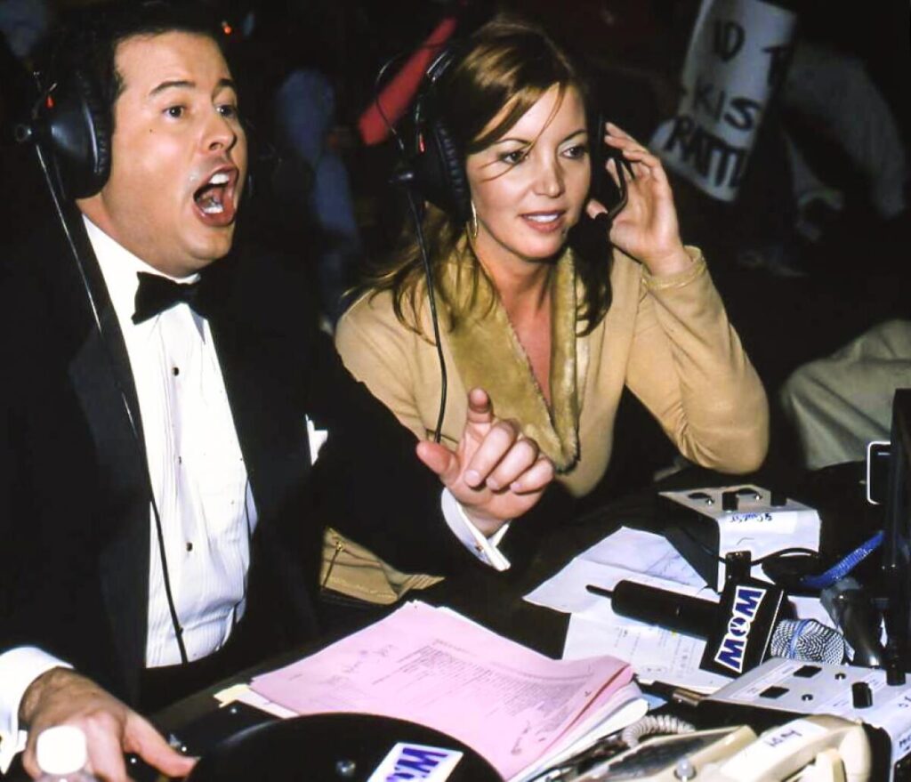 David McLane, left, and Jeanie Buss call a Women of Wrestling match in 2001.