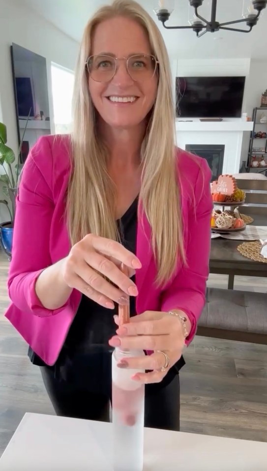 Christine Brown shows off her drastic weight loss in tight pants and a blazer while making a Plexus drink