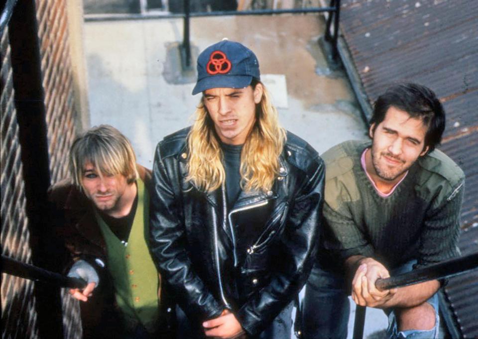 Grohl was a member of Nirvana, pictured here with bandmates Kurt Cobain, left, and Krisdt Novoselic, right, in 1990