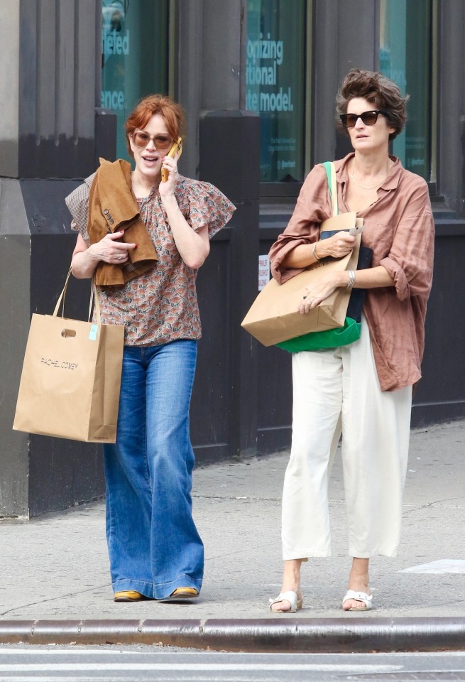 Molly Ringwald wears a bohemian-inspired blouse with flutter sleeves and wide-leg blue jeans, she adds a pop of color with mustard-yellow shoes