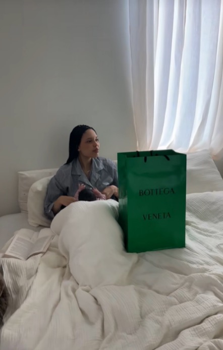 The bedroom has a simple vibe with a white bed, curtains and little decor