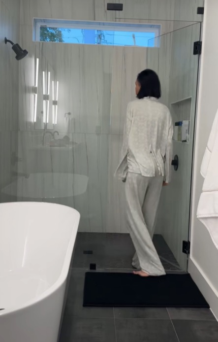 The modern bathroom has black, white and gray tones