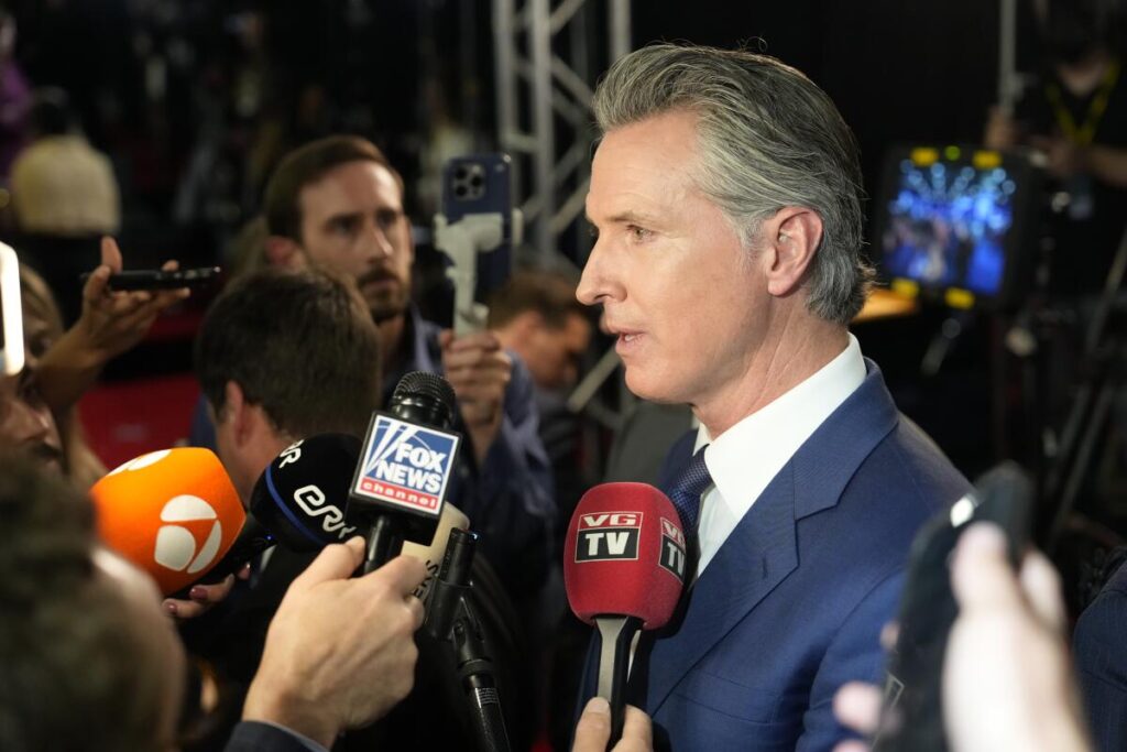 California Gov. Gavin Newsom speaks to reporters after a presidential candidate debate.