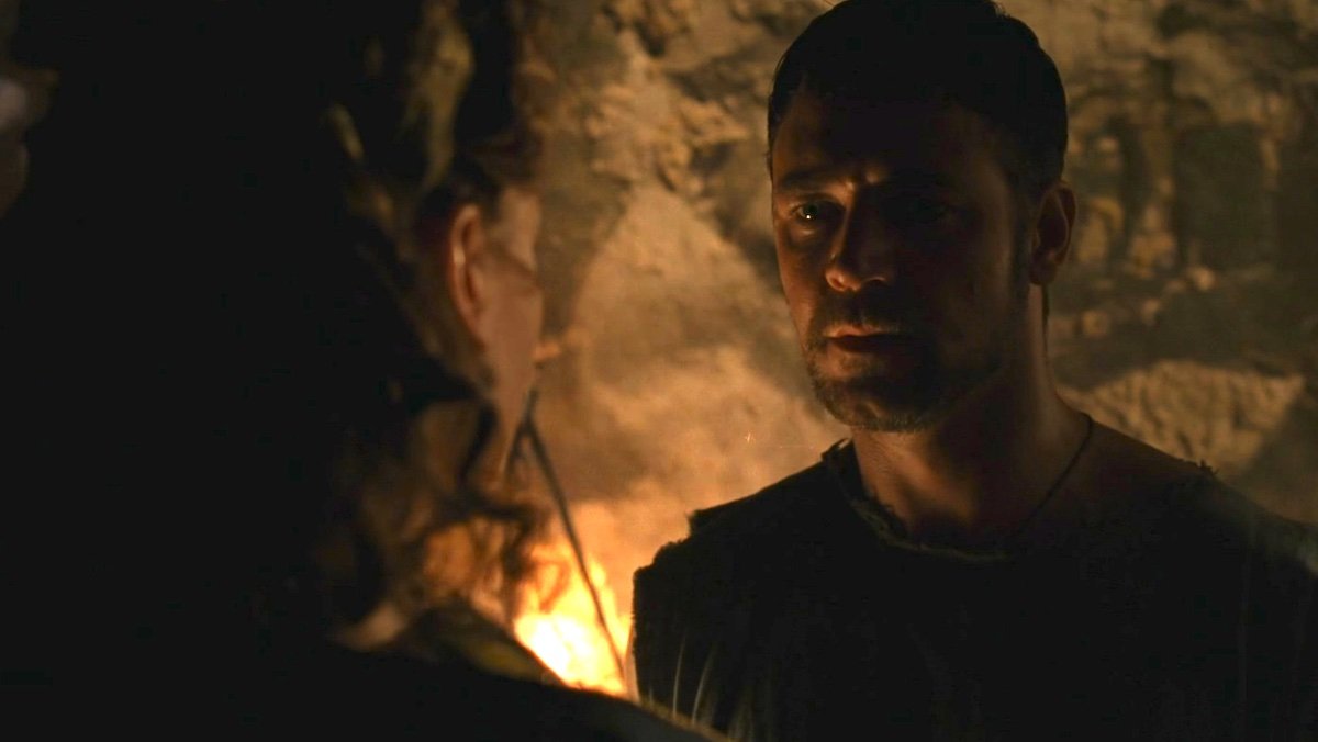 Russell Crowe as Maximus in Gladiator talking to Lucilla in a torch-lit dungeon