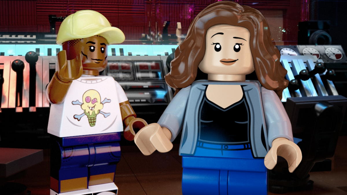 LEGO version of Pharrell Williams next to Custom Female-presenting Minifigure with recording studio as background