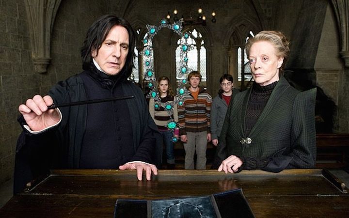 In a still from a "Harry Potter" film, Alan Rickman, as Professor Snape, and Smith, as Professor McGonagall, stand in front of Emma Watson, Rupert Grint and Daniel Radcliffe (in character as Hermione, Ron and Harry, respectively). 