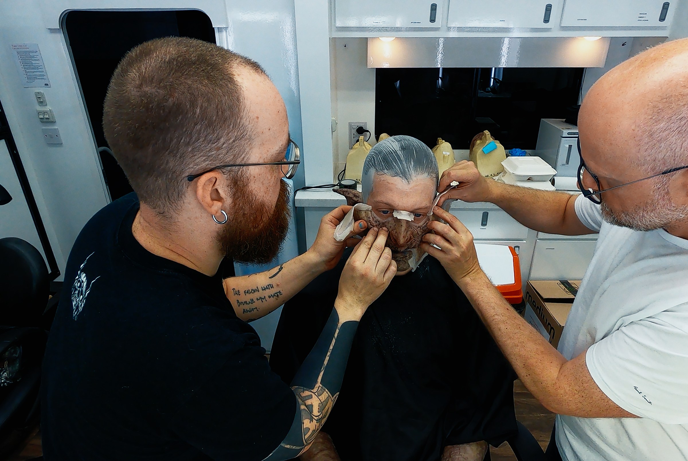 Prosthetics Artist Patt Foad (left); Robert Strange (center); Prosthetics Designer Barrie Gower midway through applying orc makeup to Robert Strange