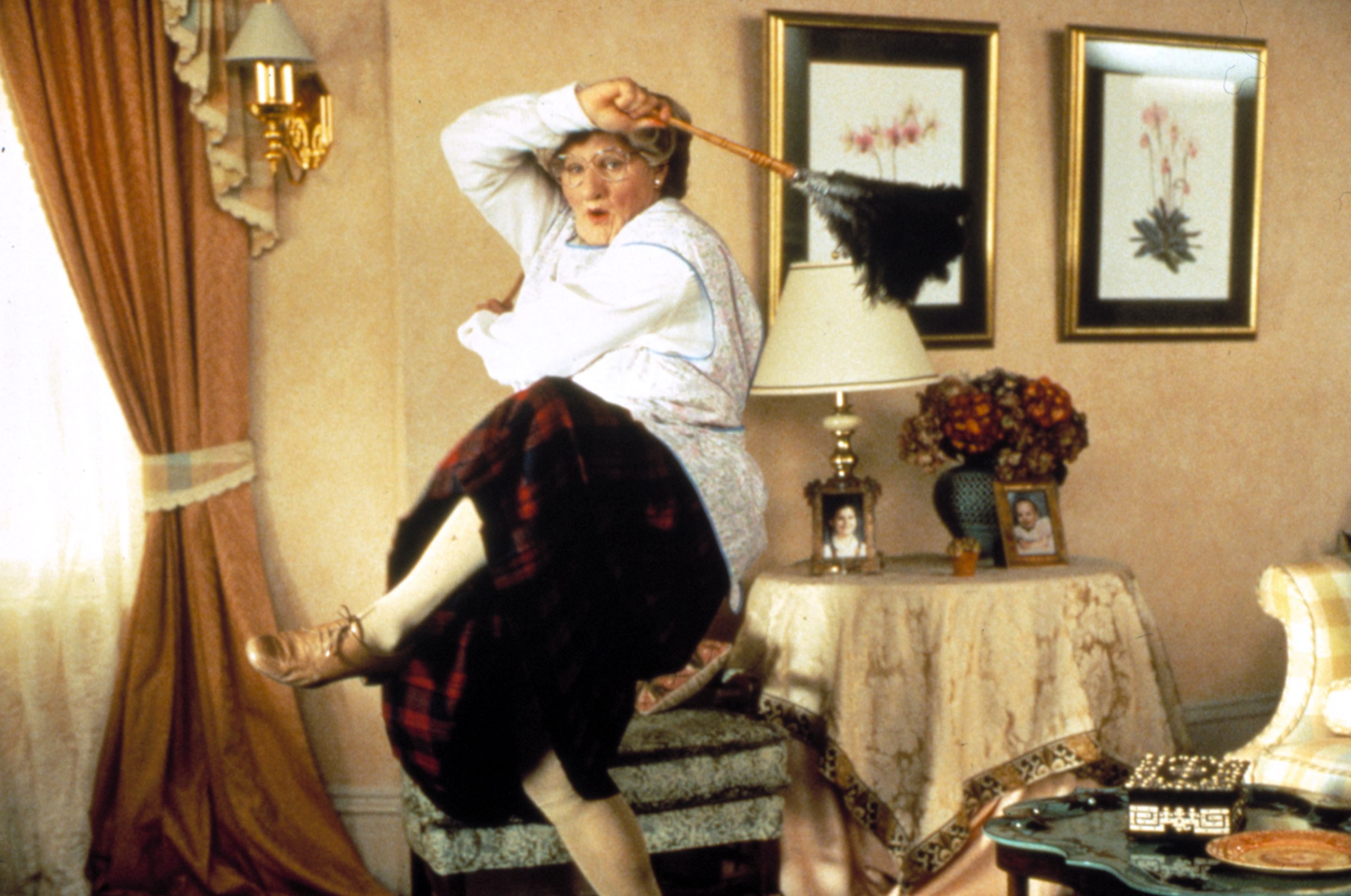 Robin Williams dressed as an old woman, dancing while cleaning the house in Mrs. Doubtfire