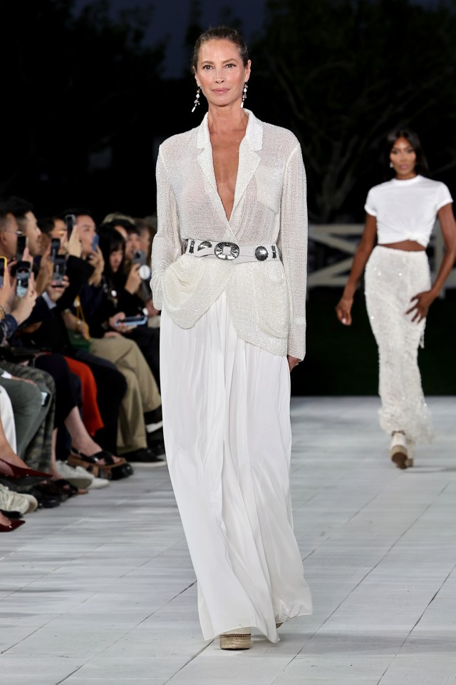 Christy Turlington walks the runway for the Ralph Lauren fashion show wearing a sheer blazer and chiffon skirt on September 5, 2024