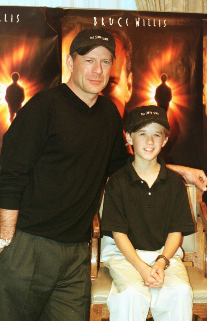 Bruce Willis, left, and Haley Joel Osment are seen at a preview of the film "The Sixth Sense."