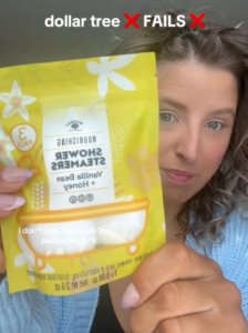 @marissainthemidwest holding Nourishing Shower Steamer product from dollar tree