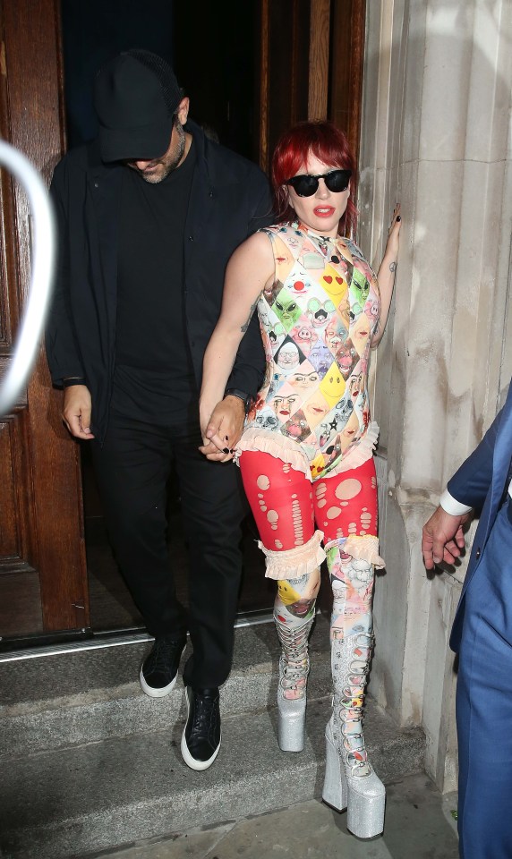 Lady Gaga wore four different outfits in less than 24 hours, pictured in an emoji top with partner Michael Polansky