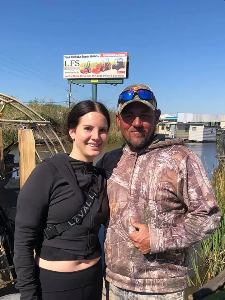 Singer Lana Del Rey poses with alligator tour guide Jeremy Dufrene during her trip to Louisiana