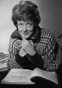 Smith in 1963, reading a script shortly after she was named Stage Actress of the Year by the Variety Club of Great Britain.