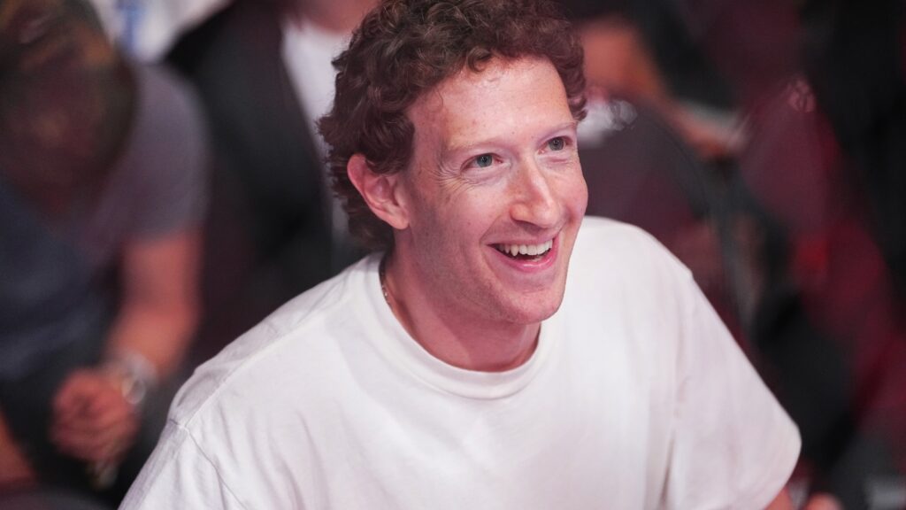 Mark Zuckerberg smiling in a white t-shirt