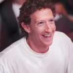 Mark Zuckerberg smiling in a white t-shirt