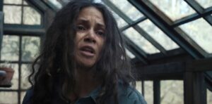 Mama (Halle Berry), wild-haired and looking drained, stands in a dilapidated greenhouse in Never Let Go