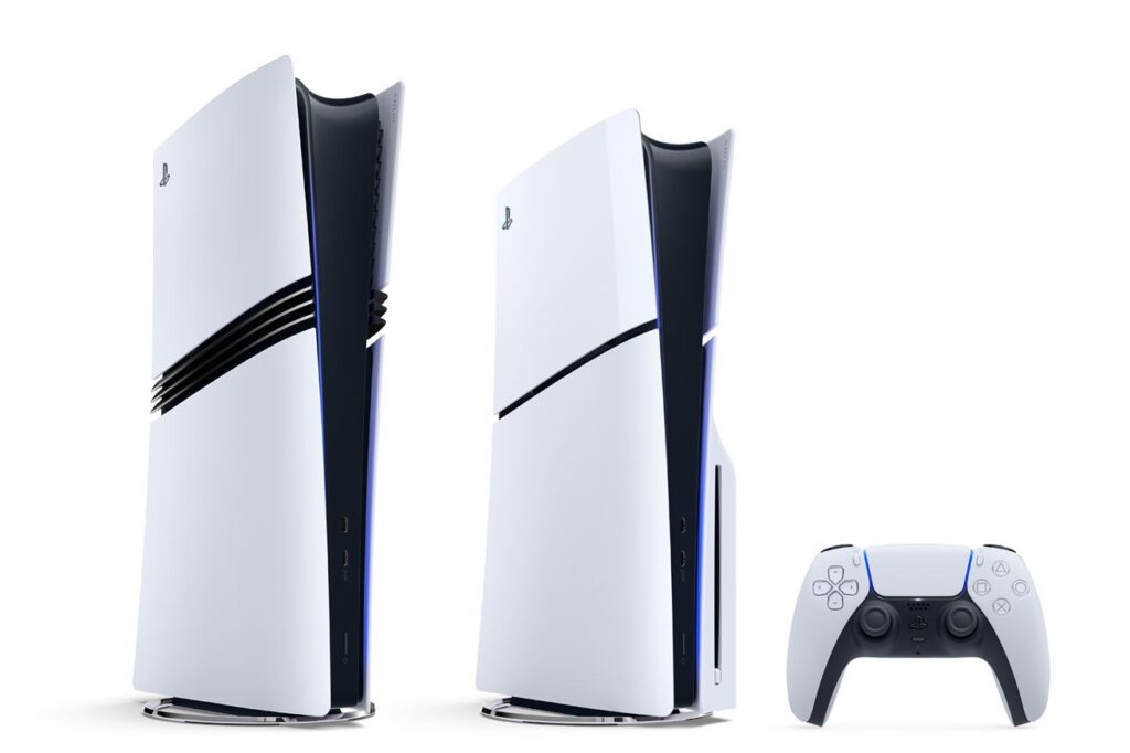 PlayStation 5 Pro standing next to a standard PlayStation 5 and a DualSense controller