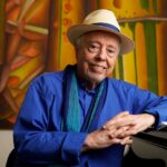 Brazilian musician Sergio Mendes poses for a portrait at home in Los Angeles, May 2021