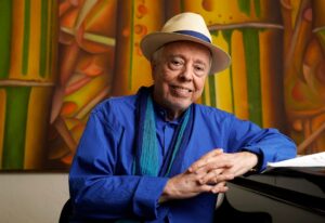 Brazilian musician Sergio Mendes poses for a portrait at home in Los Angeles, May 2021