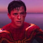 Tom Holland looking angry as Spider-Man. against a blue and purple background, with cuts on his face and sweaty hair