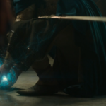 Elendil (Lloyd Owen) grabs a palantír in Rings of Power season 2 as it shoots out some kind of power