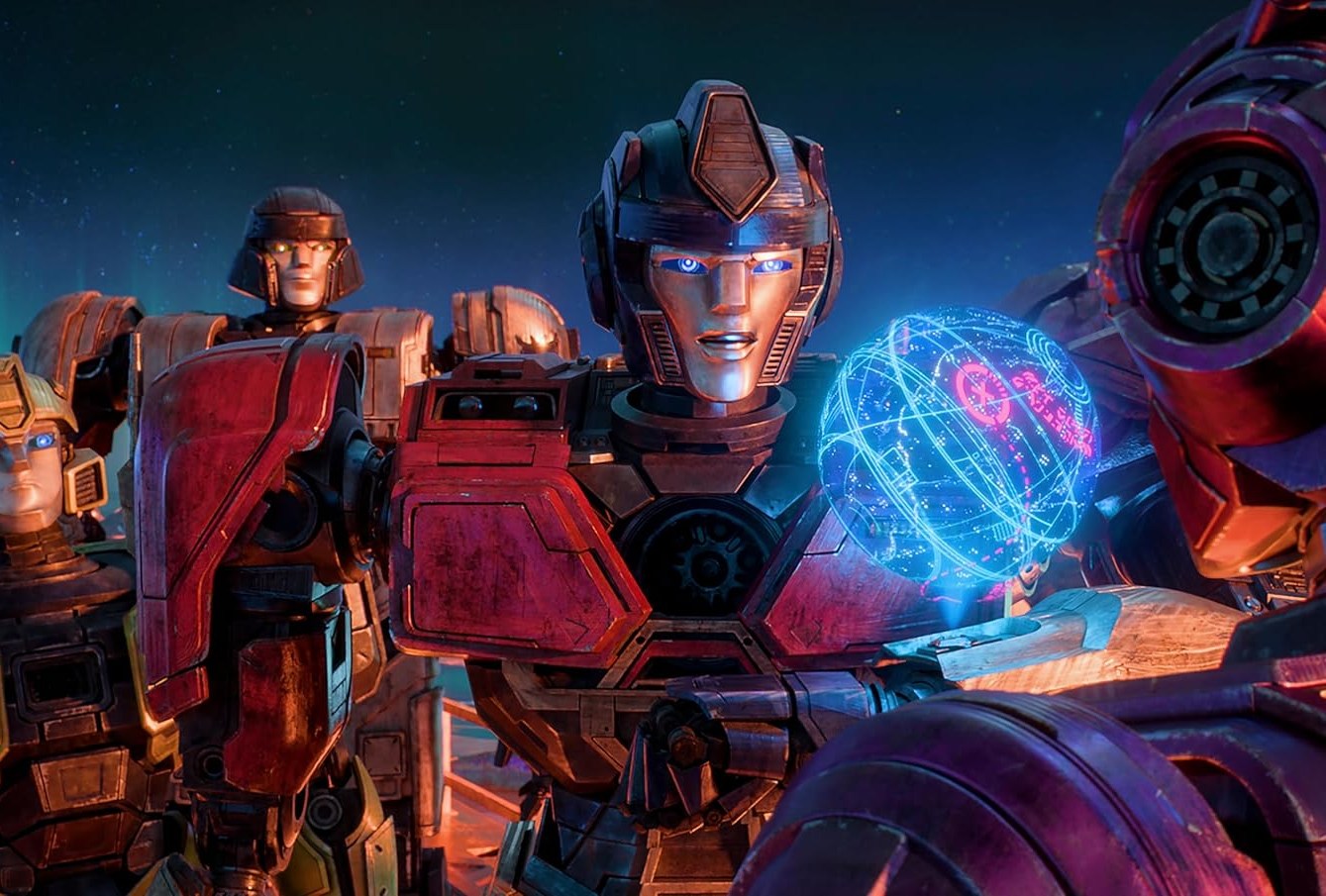 B-127, D-16, Orion Pax, and Elita-1 contemplate a map of Cybertron in a still from Transformers One