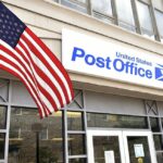 entrance to a post office with an American flag in front