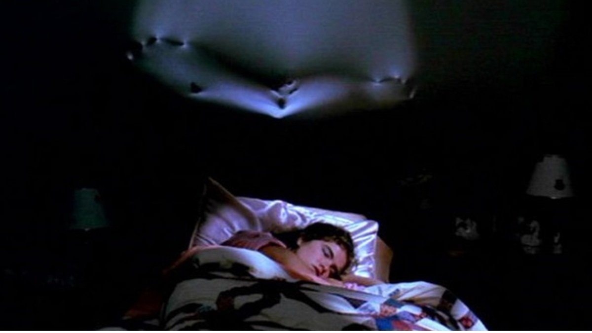 Nancy (Heather Langenkamp) has her dreams invaded by Freddy Krueger (Robert Englund) in A Nightmare on Elm Street. 