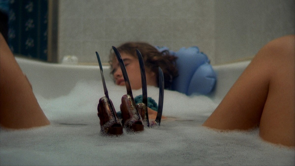 Nancy falls asleep in the tub, becoming prey for Freddy Krueger in A Nightmare on Elm Street.