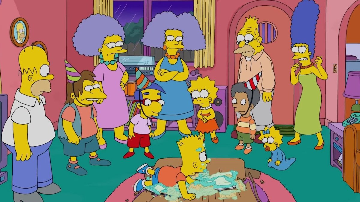 The Simpsons characters at a birthday party looking at bart lying on the ground