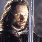 Viggo Mortensen as Aragorn holding his sword in The Lord of the Rings