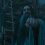 Ciarán Hinds as the Dark Wizard with his hand out holding his staff in the other on The Rings of Power