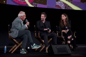 Three people speak at a post-screening Q&A.