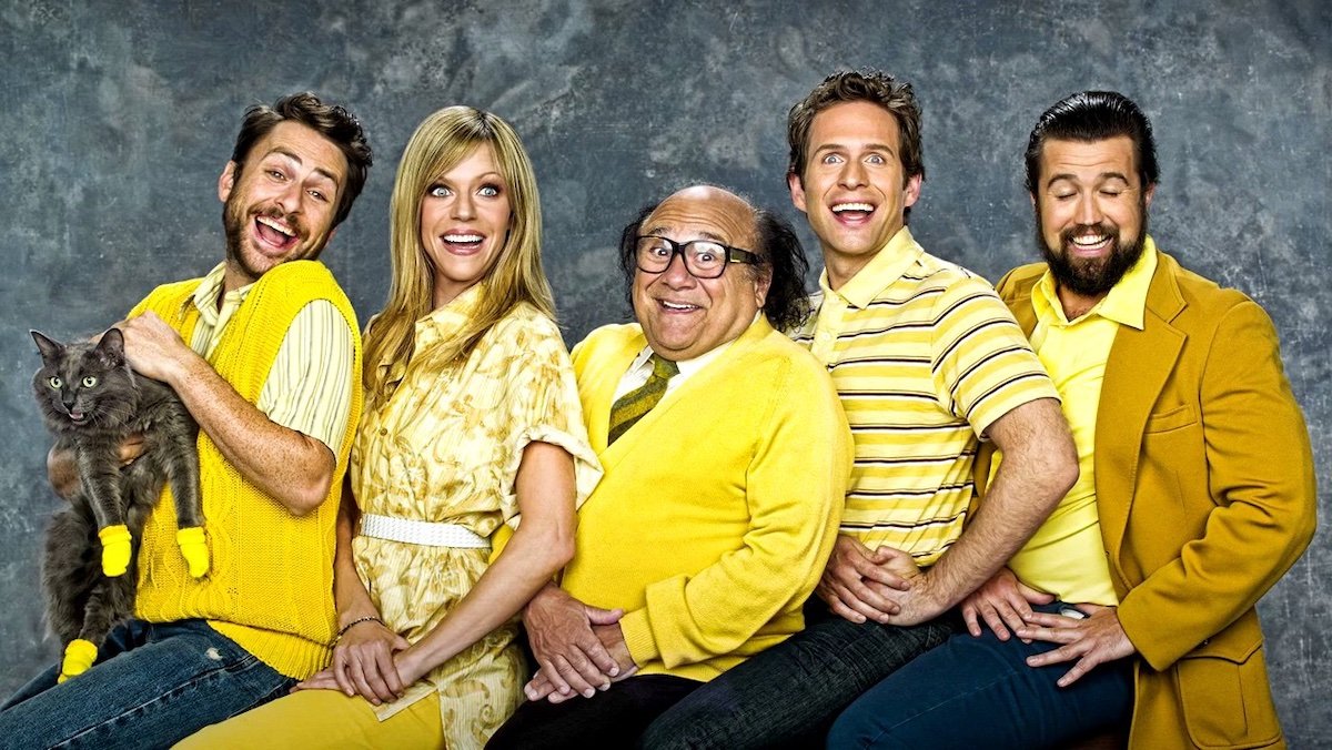 A family portrait style cast photo for It's Always Sunny in Philadelphia where everyone is wearing yellow