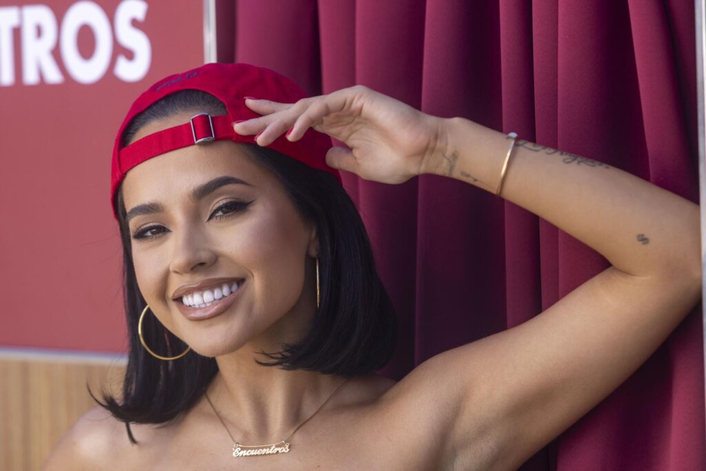 Becky G lifts her hand to her head on the set of her music video "Otro Capitulo," being filmed in Elysian Park