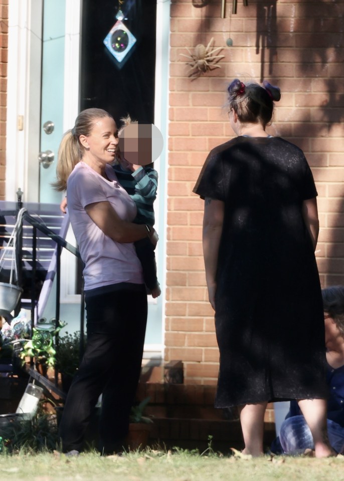 Kate held a baby and smiled at her friends