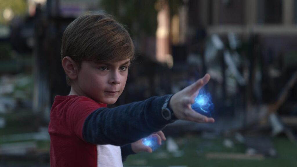 a young boy holding out his hands to cast some magic